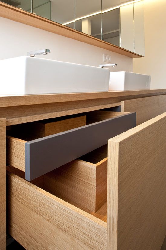 a bathroom with two sinks and drawers in it