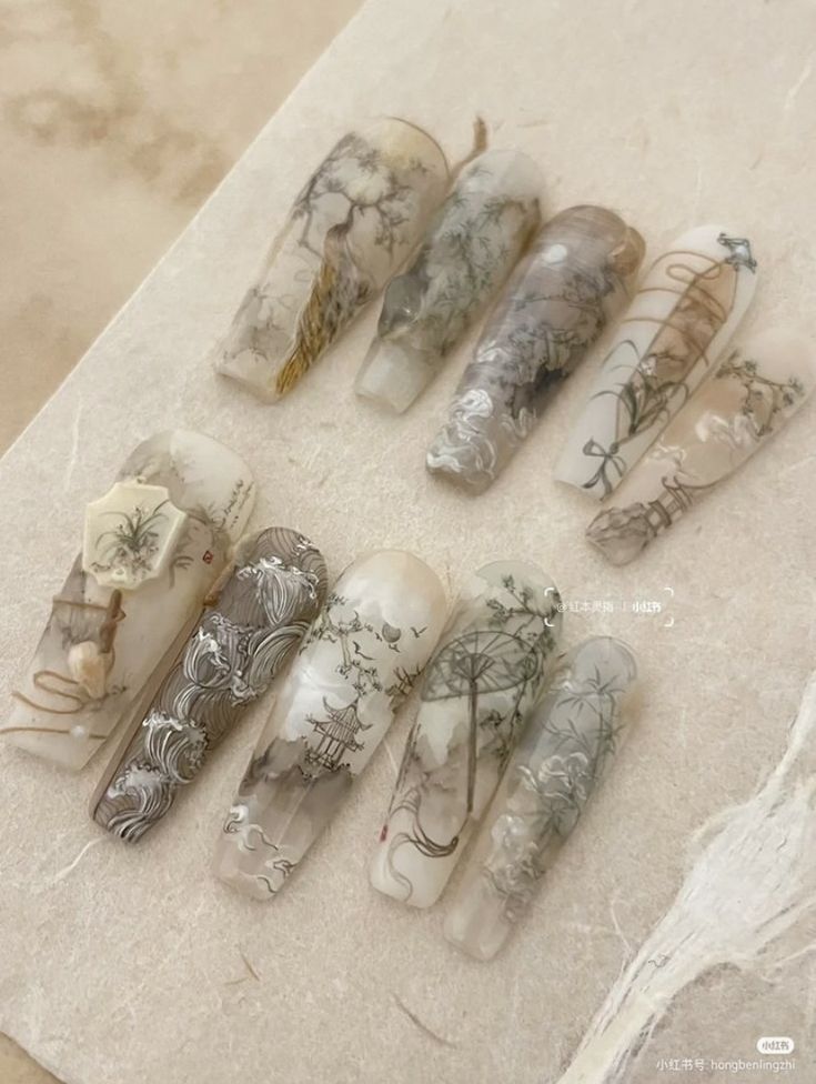 several different types of nail polish sitting on top of a marble counter next to each other