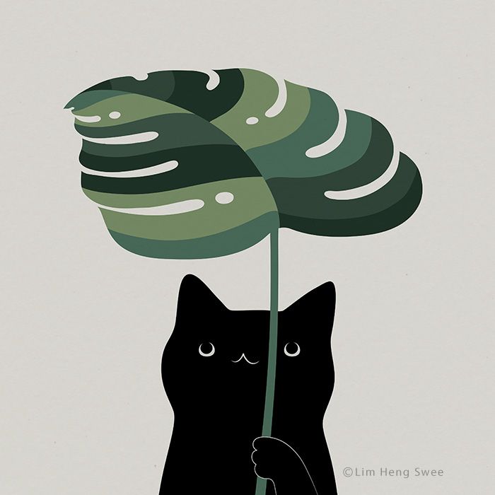 a black cat holding a large green leaf