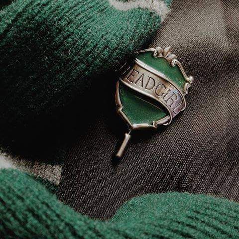 a badge on the back of a green sweater