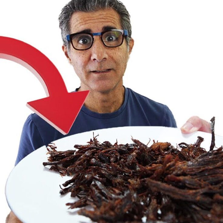 a man holding a plate with worms on it and an arrow pointing to the left