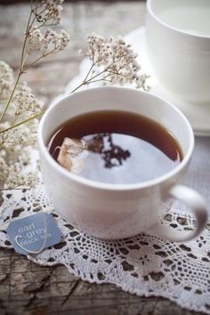 a cup of tea on a lace doily