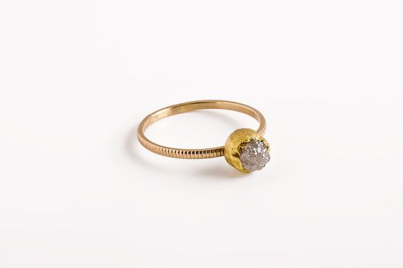 a gold and white diamond ring on a white background