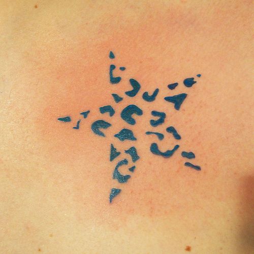 the back of a woman's shoulder with an animal print tattoo design on it