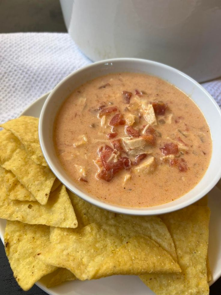 a white bowl filled with soup next to tortilla chips