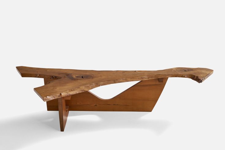 a piece of wood that is sitting on top of a wooden bench with no legs