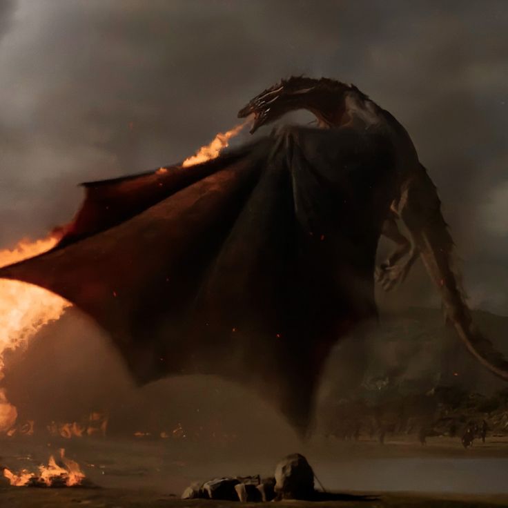 a large dragon flying through the air next to a body of water with fire coming out of it