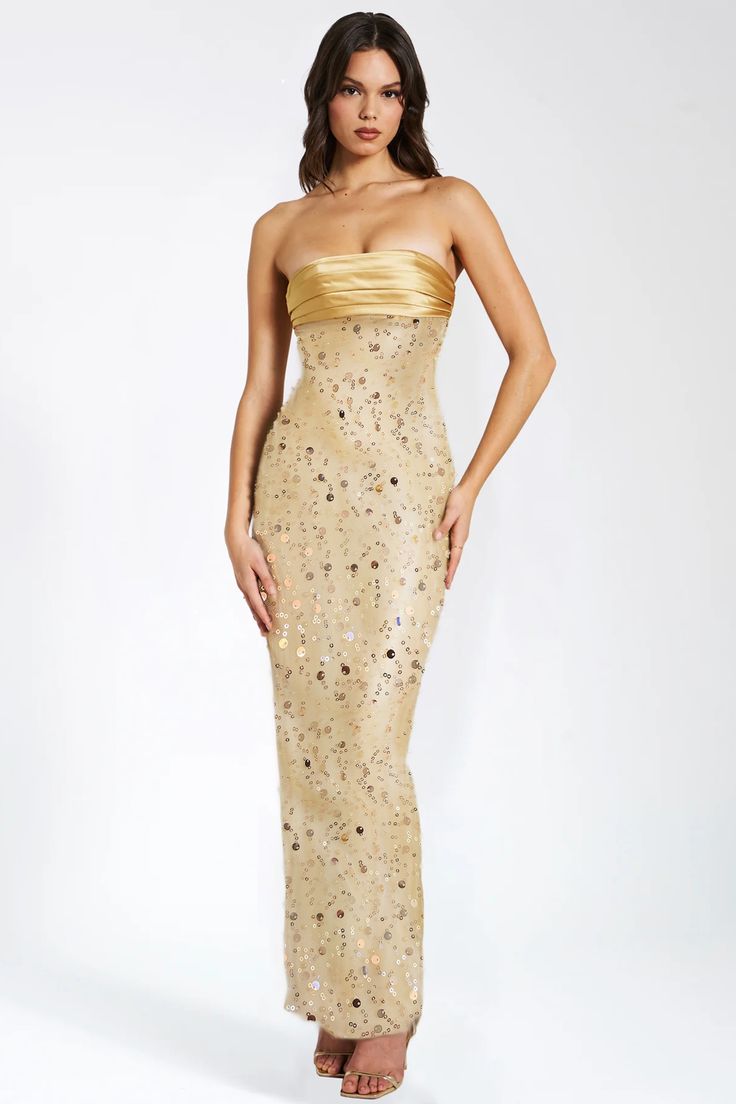 This stunning gold satin maxi dress is adorned with intricate sequins and delicate pearls, creating a truly luxurious and exclusive piece. Its flowing silhouette and exquisite detailing make it the perfect choice for any glamorous occasion. Elevate your wardrobe with this opulent dress.Material: Polyester*The above data is for flat dimensions, and the high elastic fabric can be stretched.*The above data is for reference only, please choose based on your usual purchase code.*This size chart is manually measured and may have an error of approximately 1-3CM. Gold Embellished Sleeveless Sequin Dress, Luxury Maxi Dress For Prom Season, Floor-length Evening Dress With Contrast Sequin For Festivities, Festive Floor-length Evening Dress With Contrast Sequin, Gold Sleeveless Sequin Dress For Gala, Glamorous Silk Maxi Dress For Prom Season, Glamorous Satin Gala Gown, Glamorous Satin Gown For Gala, Luxury Floor-length Maxi Dress For Party Season