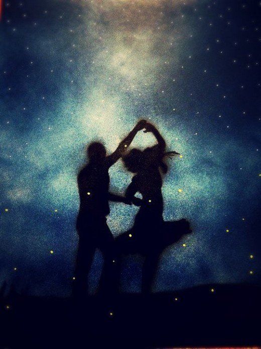 two people are dancing under the stars in the sky