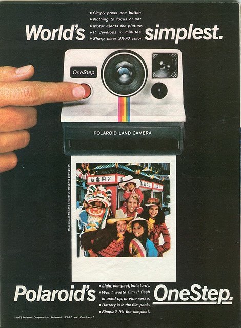 an advertisement for polaroid's one step camera with a hand pointing at it