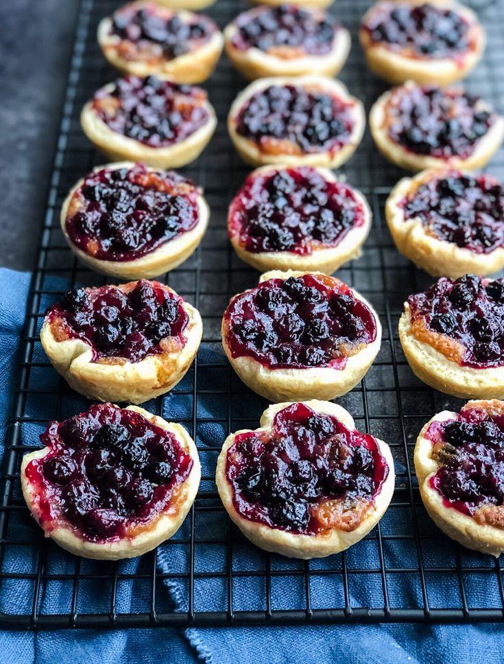 there are many cookies with blueberry toppings on them