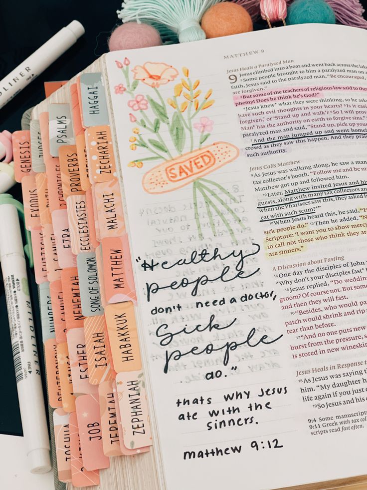 an open bible with writing on it and some crochet hooks next to it