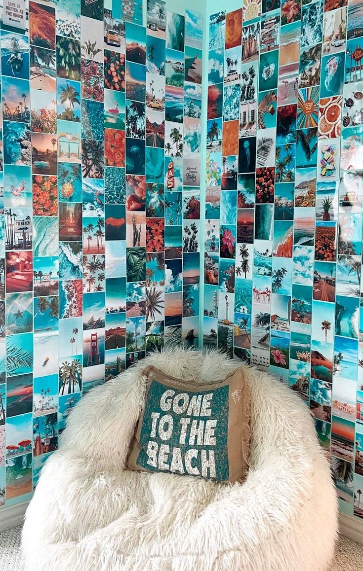 a chair with a pillow that says gone to the beach in front of a mosaic wall