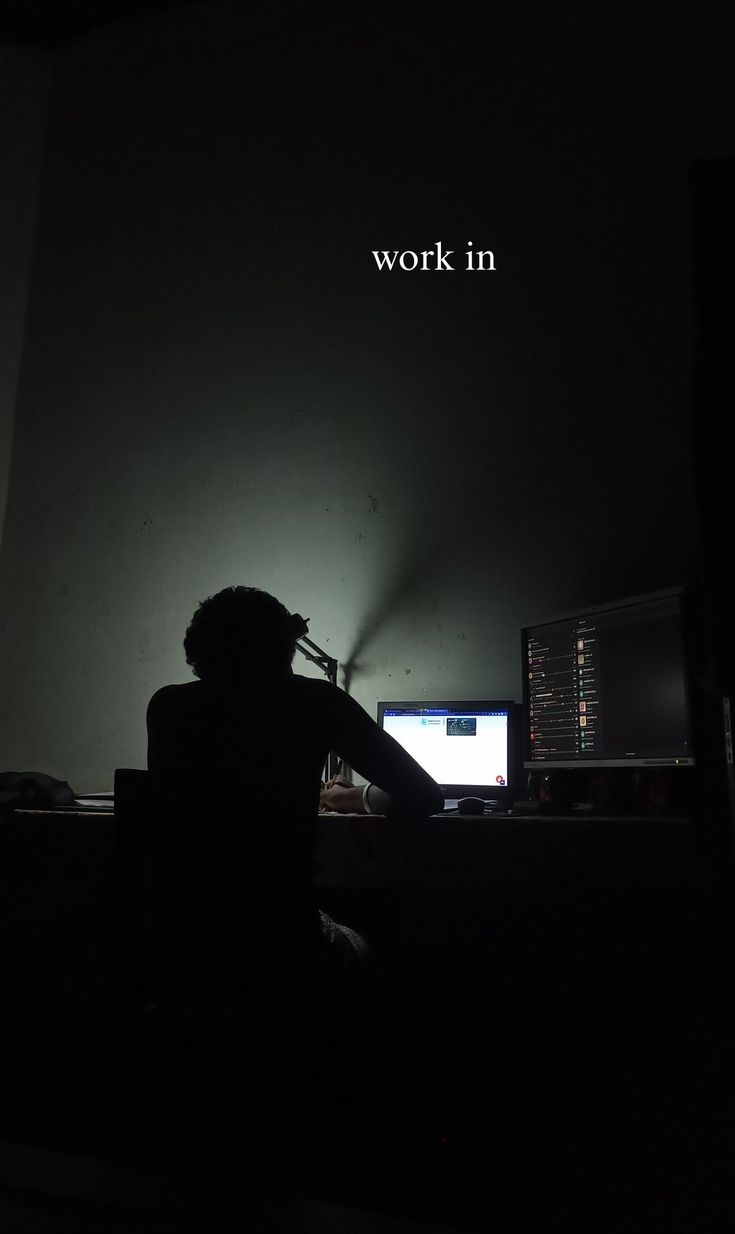 a person sitting in front of a computer desk with the words work in on it