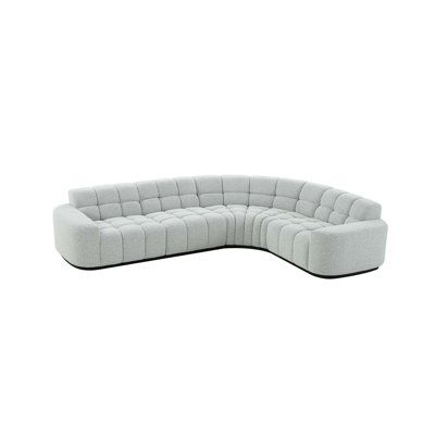 a white couch sitting on top of a white floor