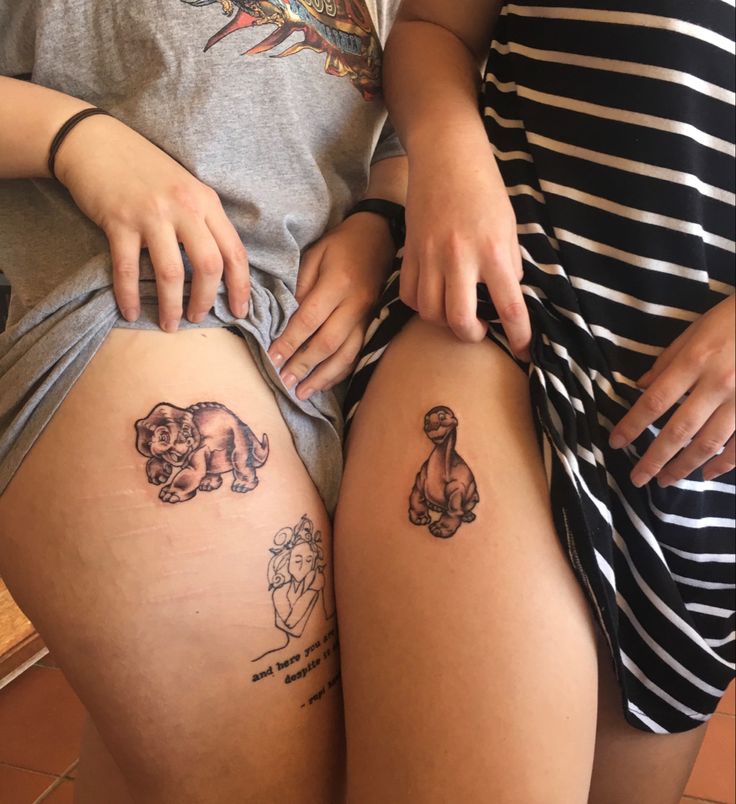 two people with tattoos on their legs