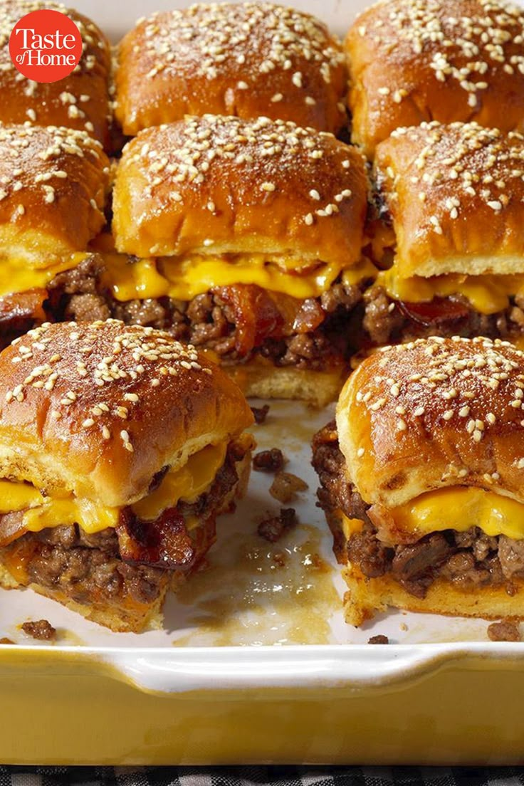 several cheeseburger sliders stacked on top of each other with melted cheese and ground beef