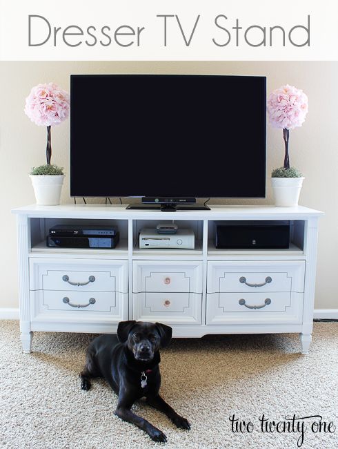 the dresser turned tv stand is painted white