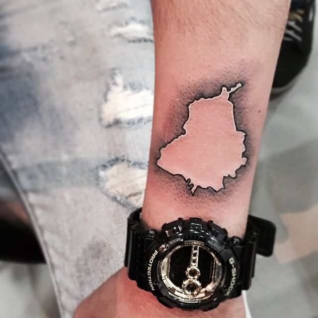 a man with a wrist tattoo has a black and white map on his left arm