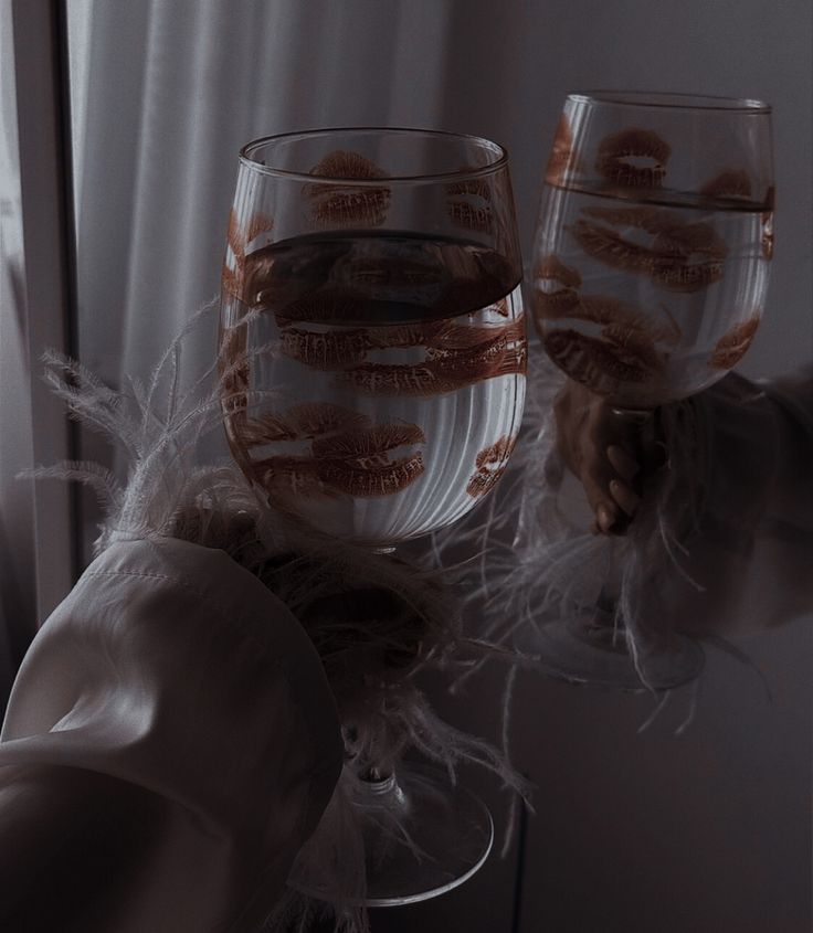 two wine glasses sitting on top of a table