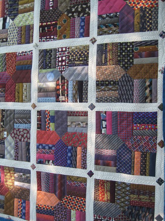 a quilted wall hanging on the side of a building