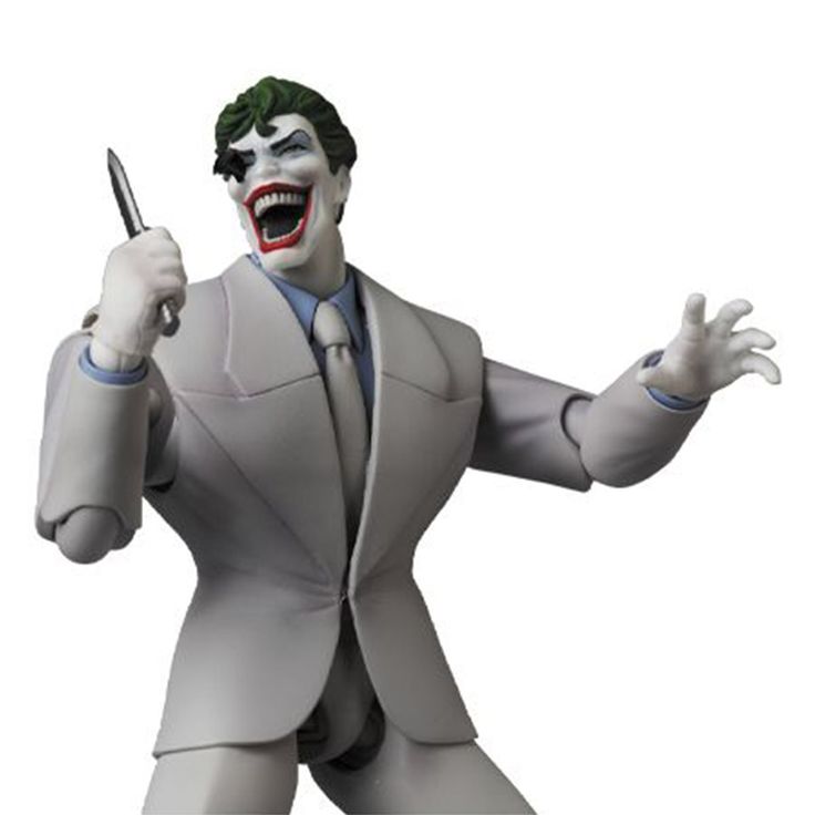 a statue of the joker holding a knife in his right hand and wearing a suit