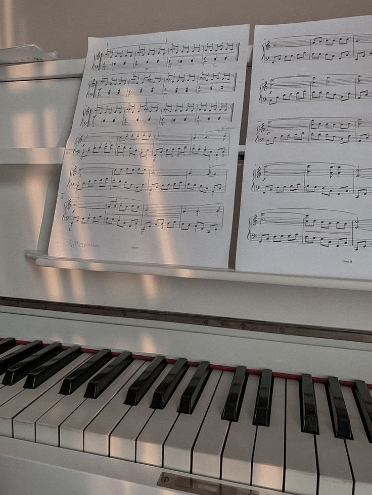 sheet music are on the piano keyboard