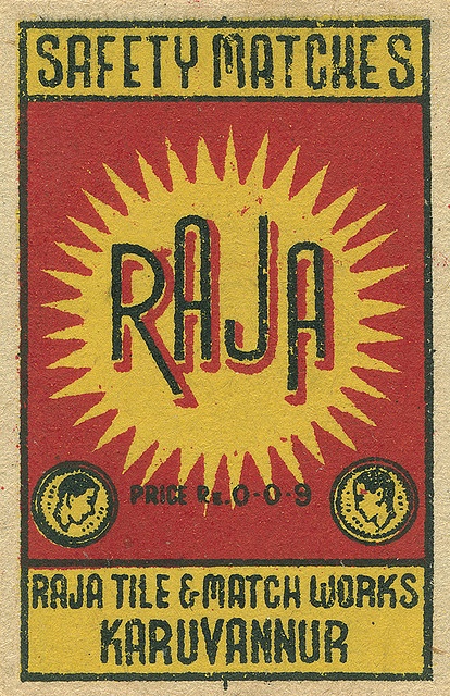 a red and yellow label with the word rau on it's back side