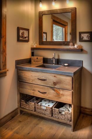 a bathroom with a sink, mirror and wooden cabinet in it's center area