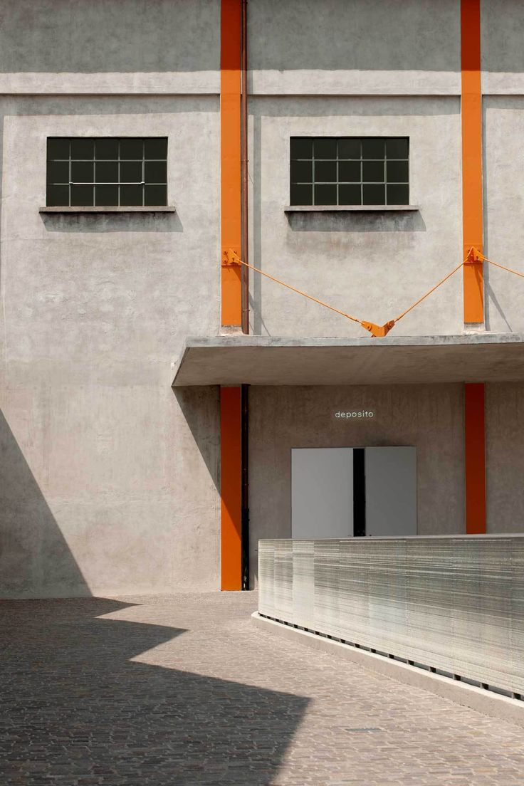 an orange and white building with two windows