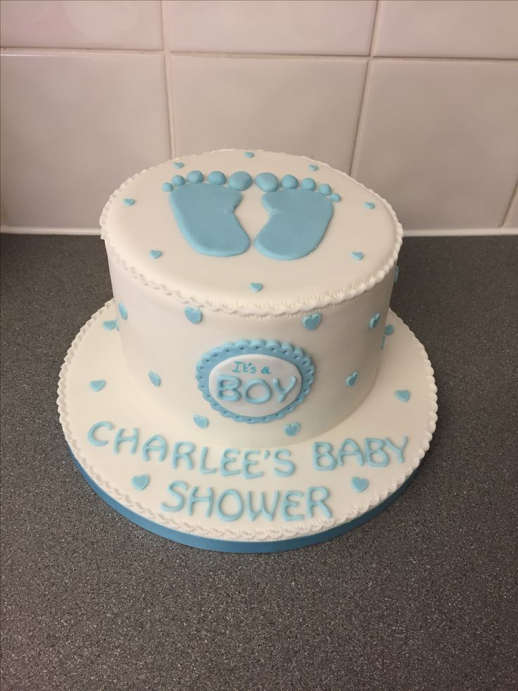 a blue and white baby shower cake on a counter