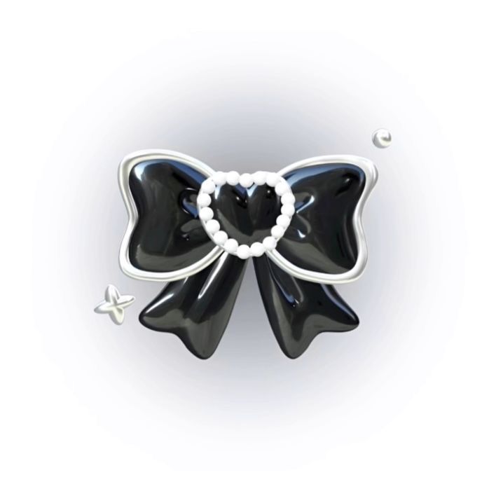 a black and white bow brooch with pearls on it's center, in the shape of a heart