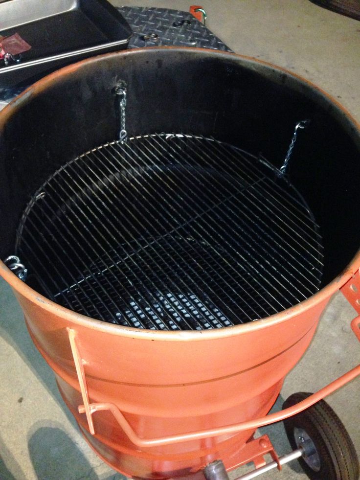 an orange bucket sitting on top of a metal cart