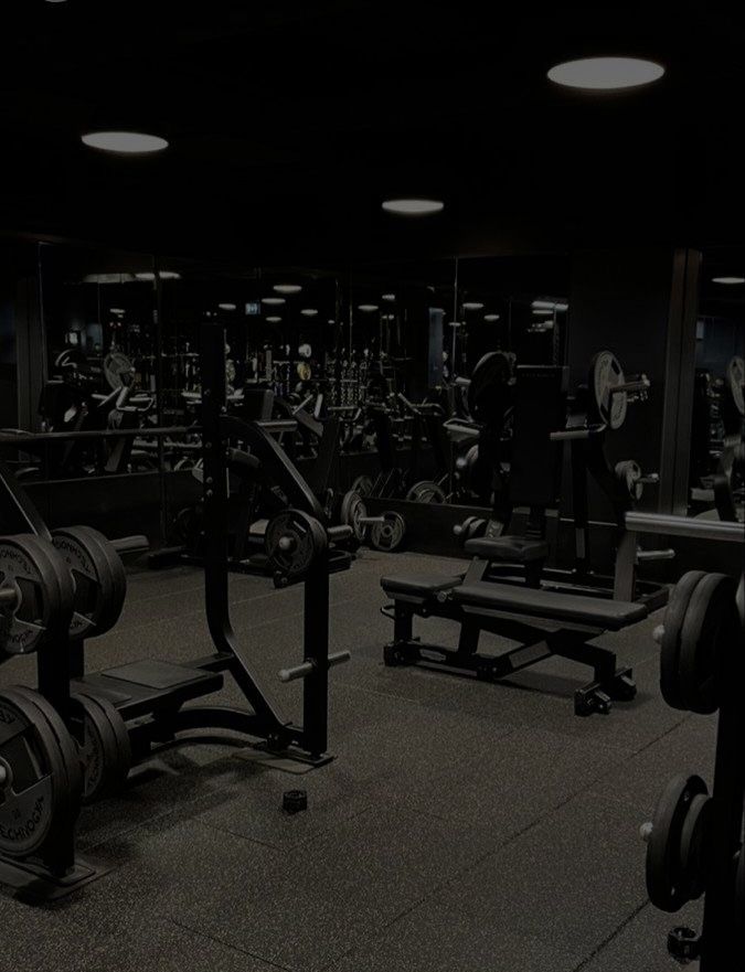 an empty gym with rows of weight machines