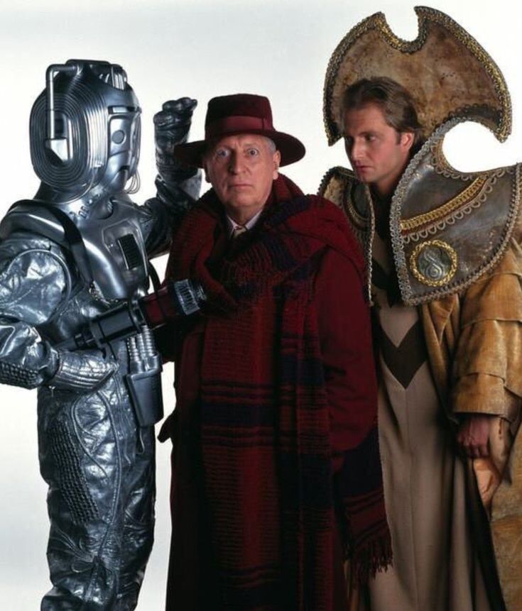 three people in costumes standing next to each other and one person wearing a costume that looks like a robot