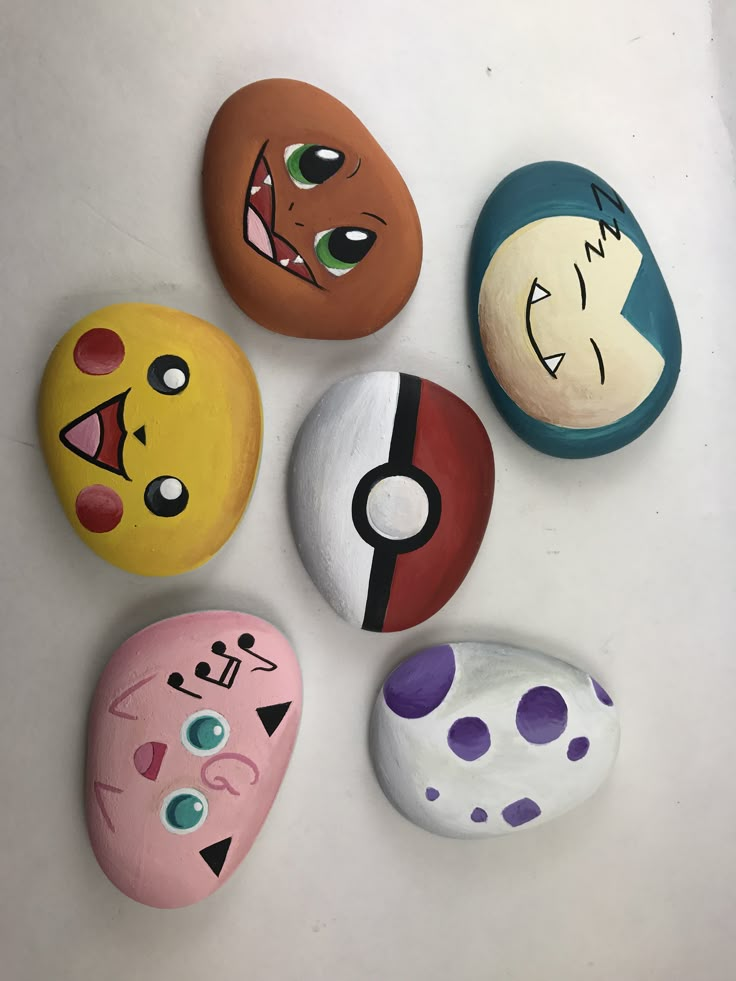 five painted rocks with different faces on them