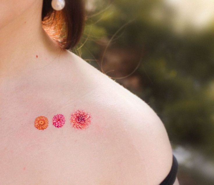 a woman with three small flowers on her chest