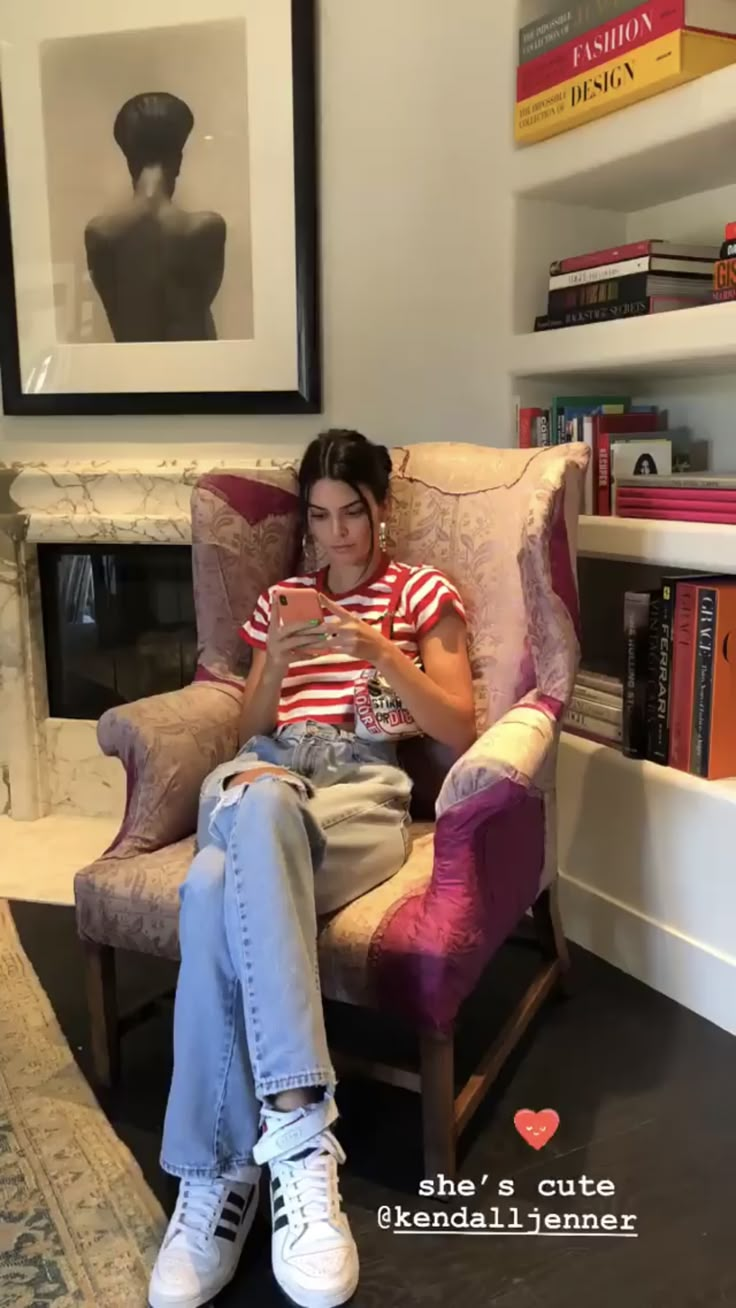 a woman sitting in a chair with her legs crossed