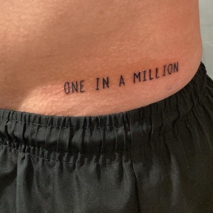 a person with a tattoo on their stomach that says one in a million