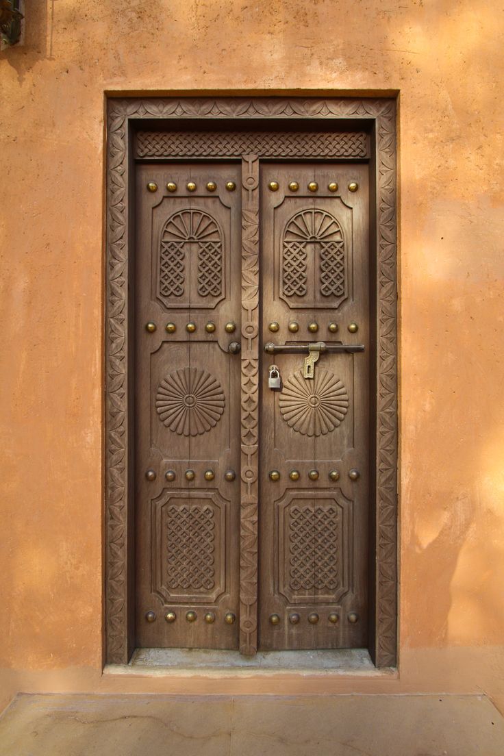 the door is made of metal and has intricate designs on it