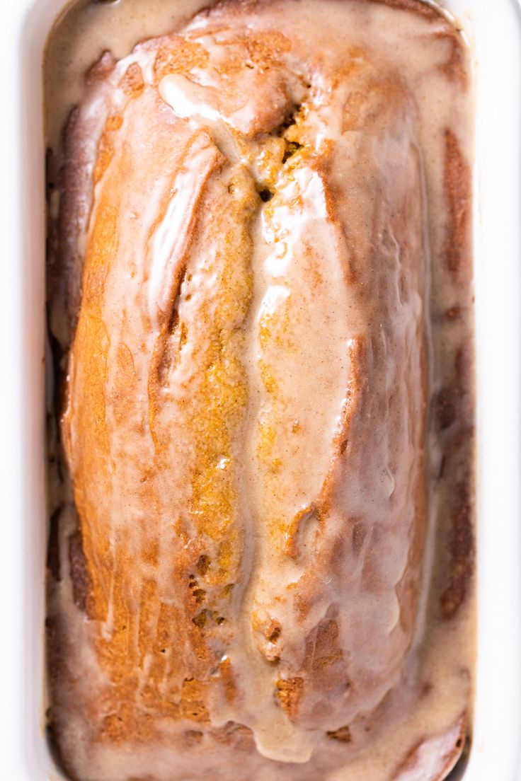 a loaf of glazed bread in a white container