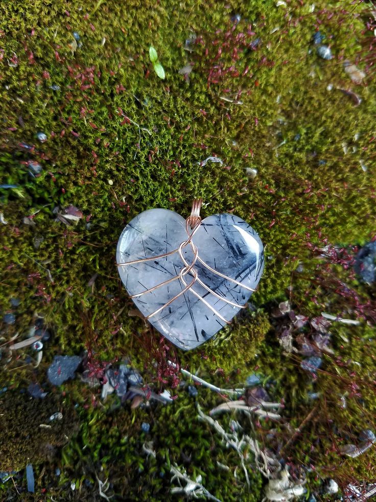 "Handmade copper wire wrapped Black Rutilated Quartz crystal heart pendant necklace. This black rutilated quartz crystal heart is wrapped in a minimalist style with bare copper wire. I love this style for it's simplicity and humanistic design as it depicts a heart inside a rib cage. This is the perfect gift to show love and appreciation to a loved one or yourself! You can choose between four different chain or cord options - 1 mm cotton cord, 2 mm cotton cord, 1 mm \"dainty\" chain, 1.7 mm \"bold\" chain. Both chain options are made from tarnish resistant copper. Both cotton cord options come with a very generous length to be knotted or finished as you like! Please be mindful that bare copper wire will start to show patina and tarnish over time. The aging of copper wire can be either beaut Heart Shaped Crystal Wire Wrap, Wire Wrap Rocks, Heart Wire Wrap, Wire Wrapped Heart Stone, Wire Wrapped Rocks, Easy Wire Wrapping Stones, Wire Wrapped Stones, Wire Wrapped Crystals, Wire Wrapped Crystal Necklace