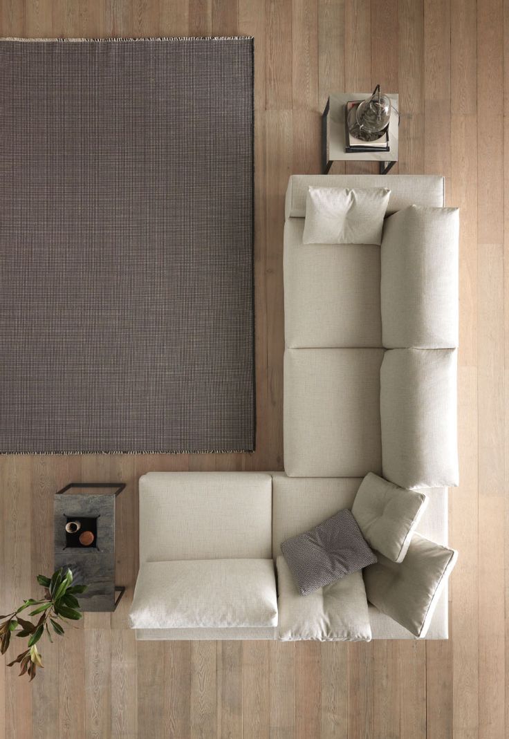 an overhead view of a living room with white furniture