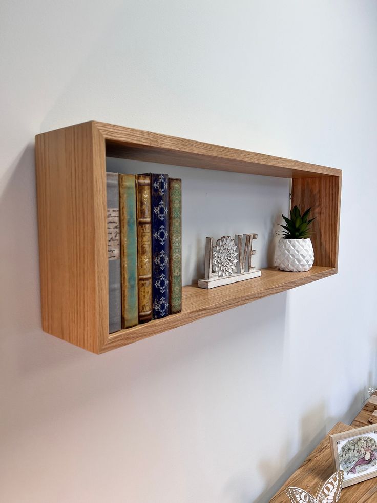 a wooden shelf with books on top of it