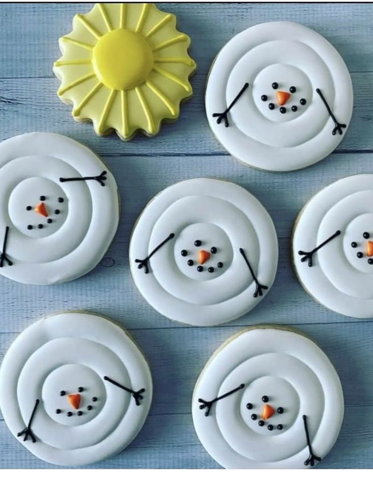 some cupcakes with frosting on them are arranged in the shape of snowmen