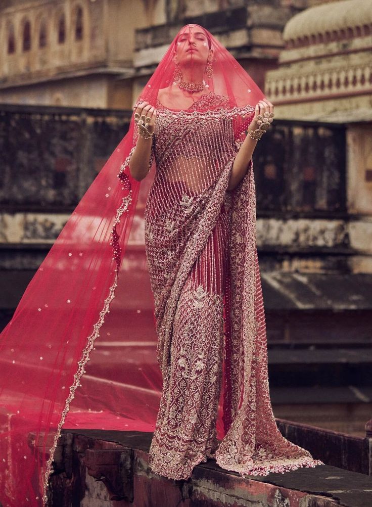 a woman in a pink sari and veil