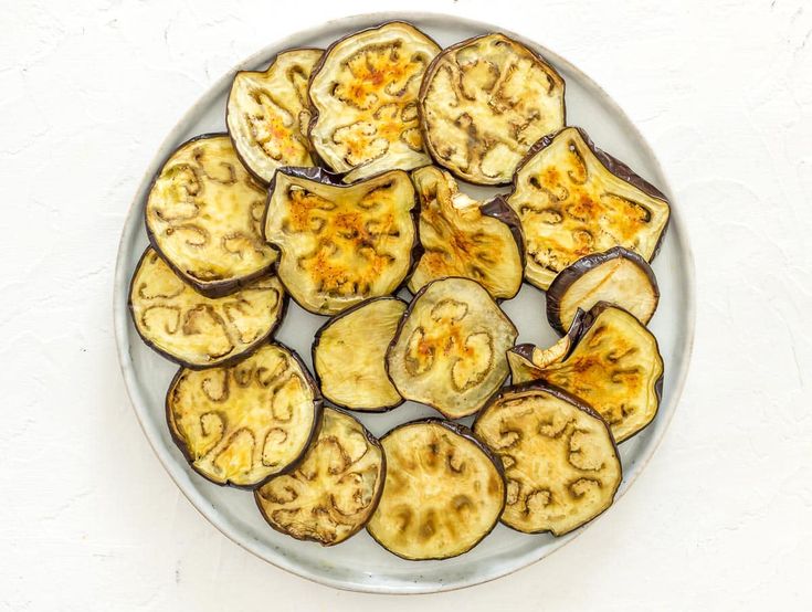 a plate full of sliced up bananas on a table