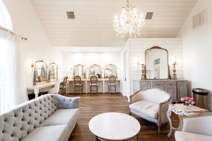 a living room filled with furniture and a chandelier