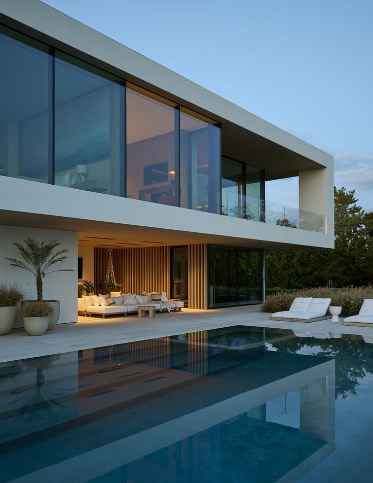 a large swimming pool in front of a modern house