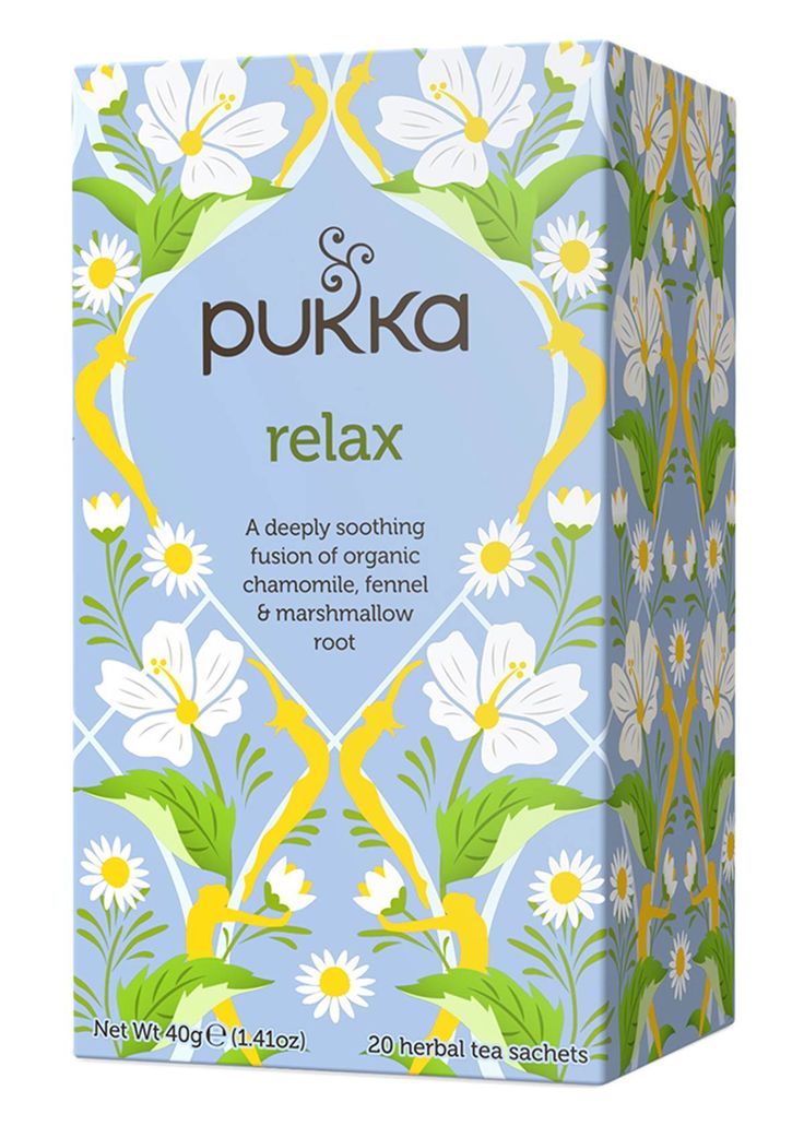 the box for pukka relax is shown in front of it's white and yellow flowers